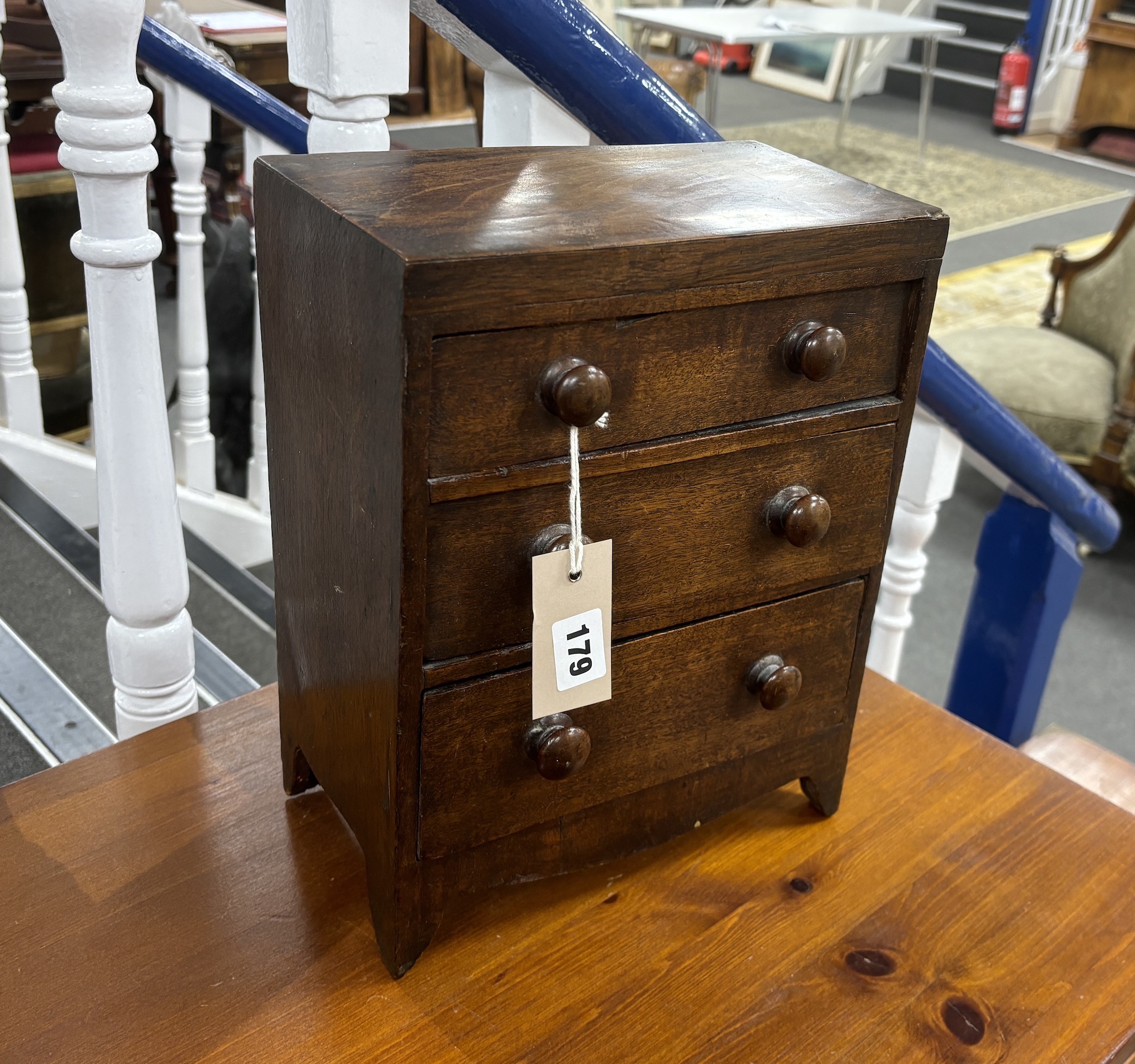 An early 19th century mahogany three drawer miniature chest, width 25cm, depth 14cm, height 32cm